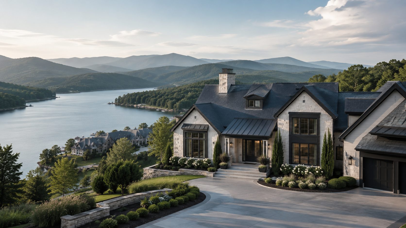 Modern East Tennessee lakefront luxury home with blue-gray roof, stone exterior, mountain views, and landscaped grounds.